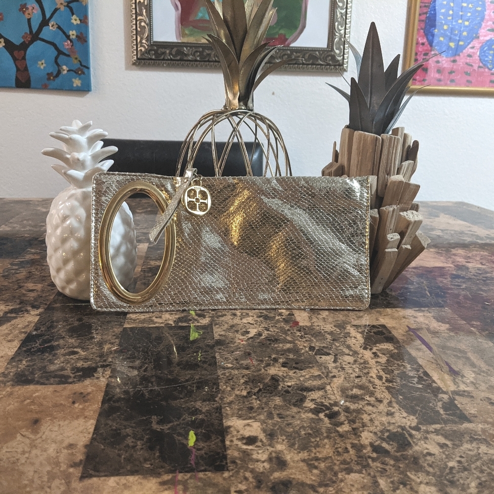 Iman gold tone clutch